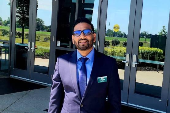 OHIO Student Trustee Pankaj Karna smiles in front of a building. 