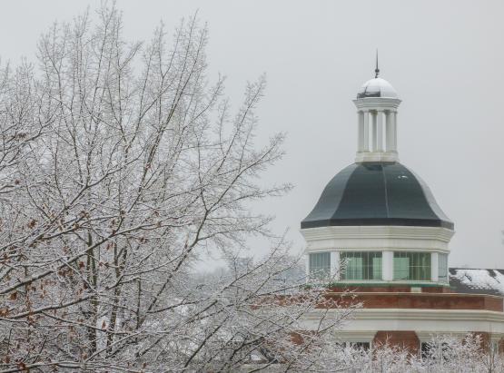  An OHIO building is shown next to a tree covered in ice and snow on a winter&amp;#039;s day at Ohio University 