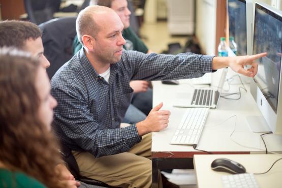  Ryan Fogt works with meterology students in the Scalia Lab for Atmospheric Analysis 