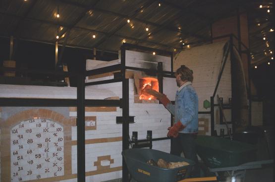  Sam McCall is shown working with a kiln 