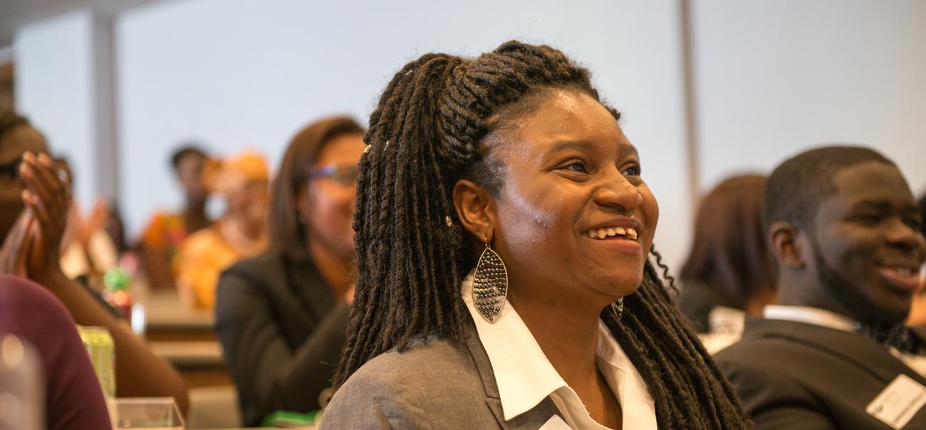 Business student smiles during a presentation