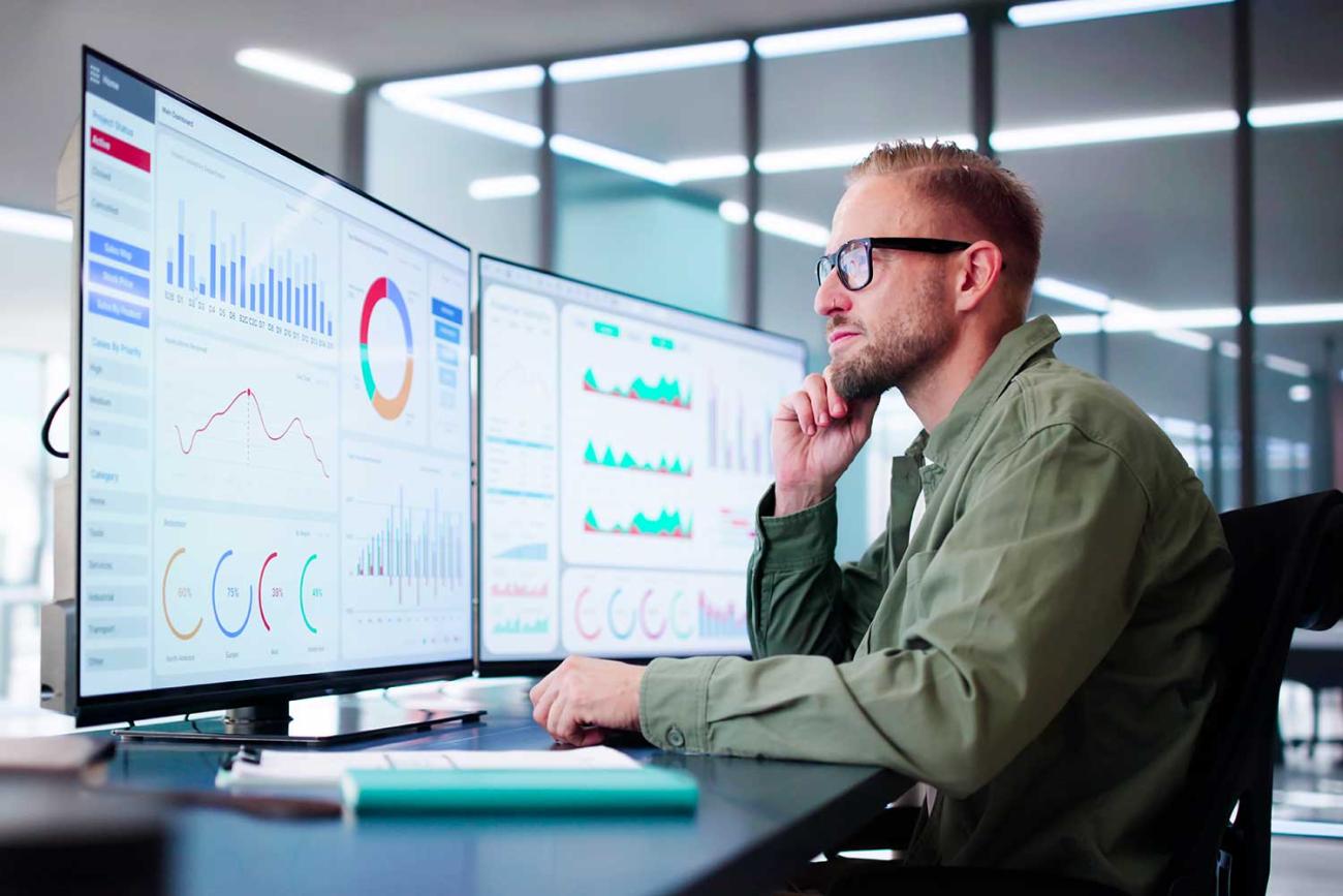 Sports Analytics certificate student reviewing data on computer monitor