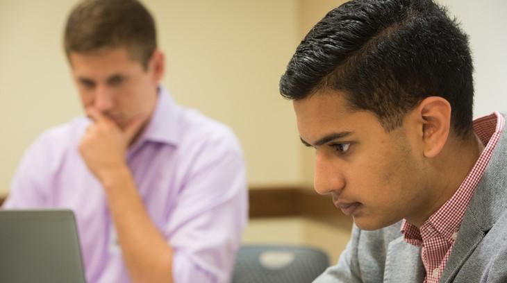 Students study together on their computers