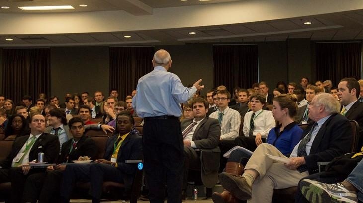 Business professor gives a lecture to a classroom full of students