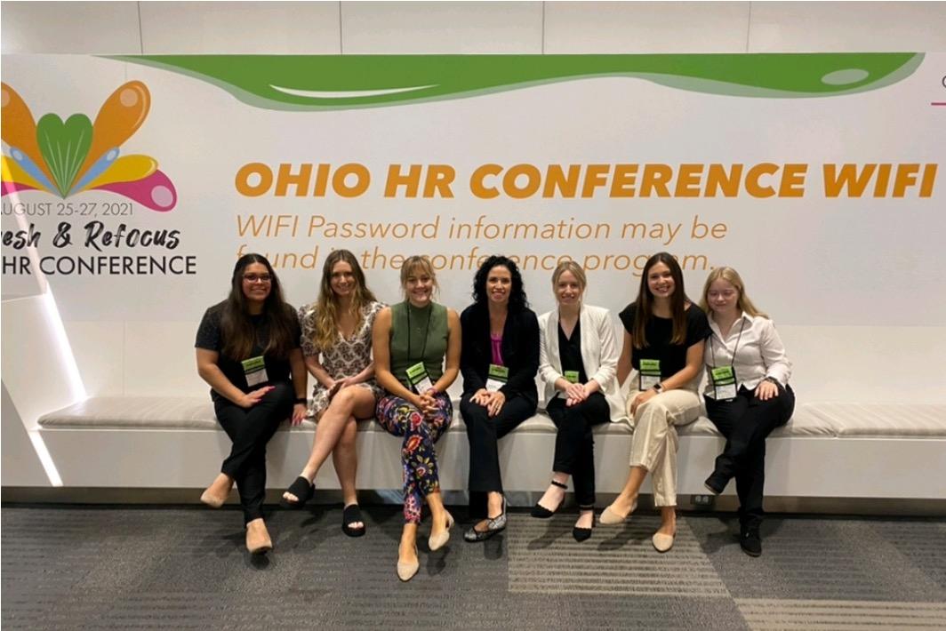 students in front of HR Conference sign