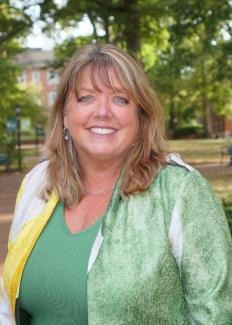 woman smiling on college green