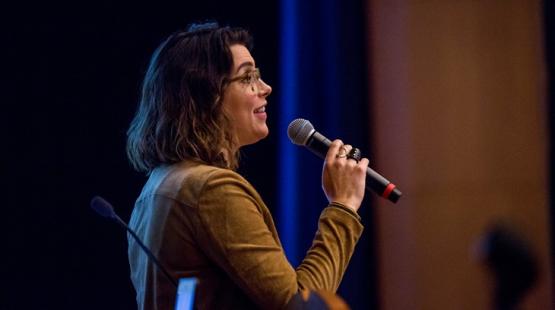 College of Business alumni speaks into a microphone