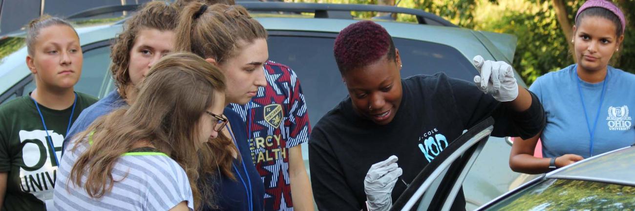 Students dust for fingerprints at STEMstart field experience