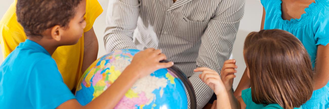 photo of children and globe