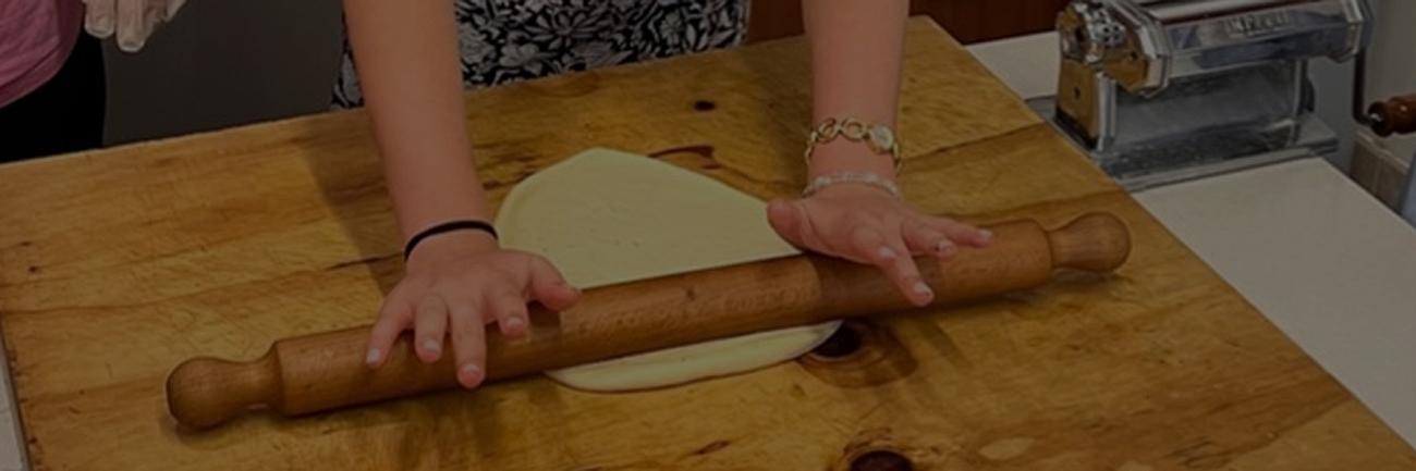 Food in Sicily students roll pasta