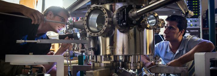 Two people working on the accelerator beam