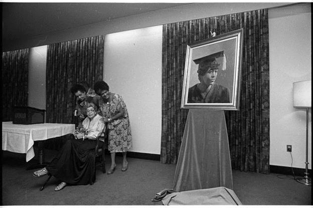 Martha Jane Hunley Blackburn (seated) at reception with her 1916 yearbook graduation painting rendered as an oil painting. The painting is now on display in Mem Aud. 