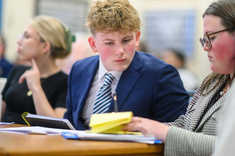 Two students confer at the Summer Law & Trial Institute mock trial in the Athens Courthouse.