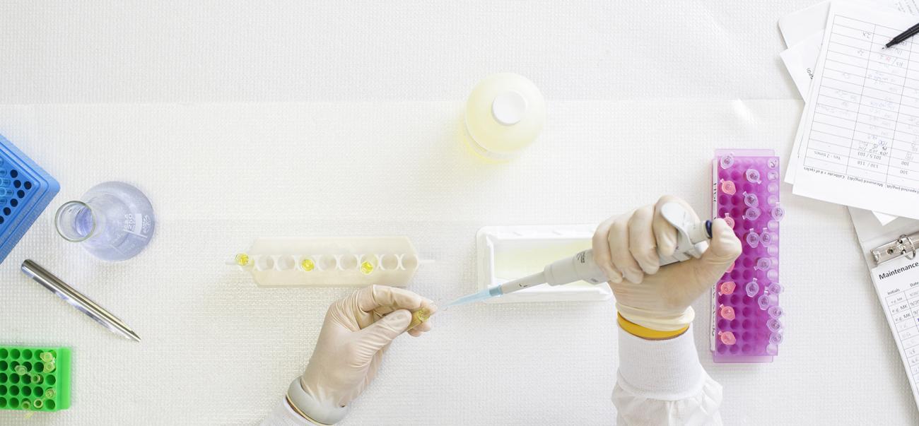 Picture of hands filling up test tubes