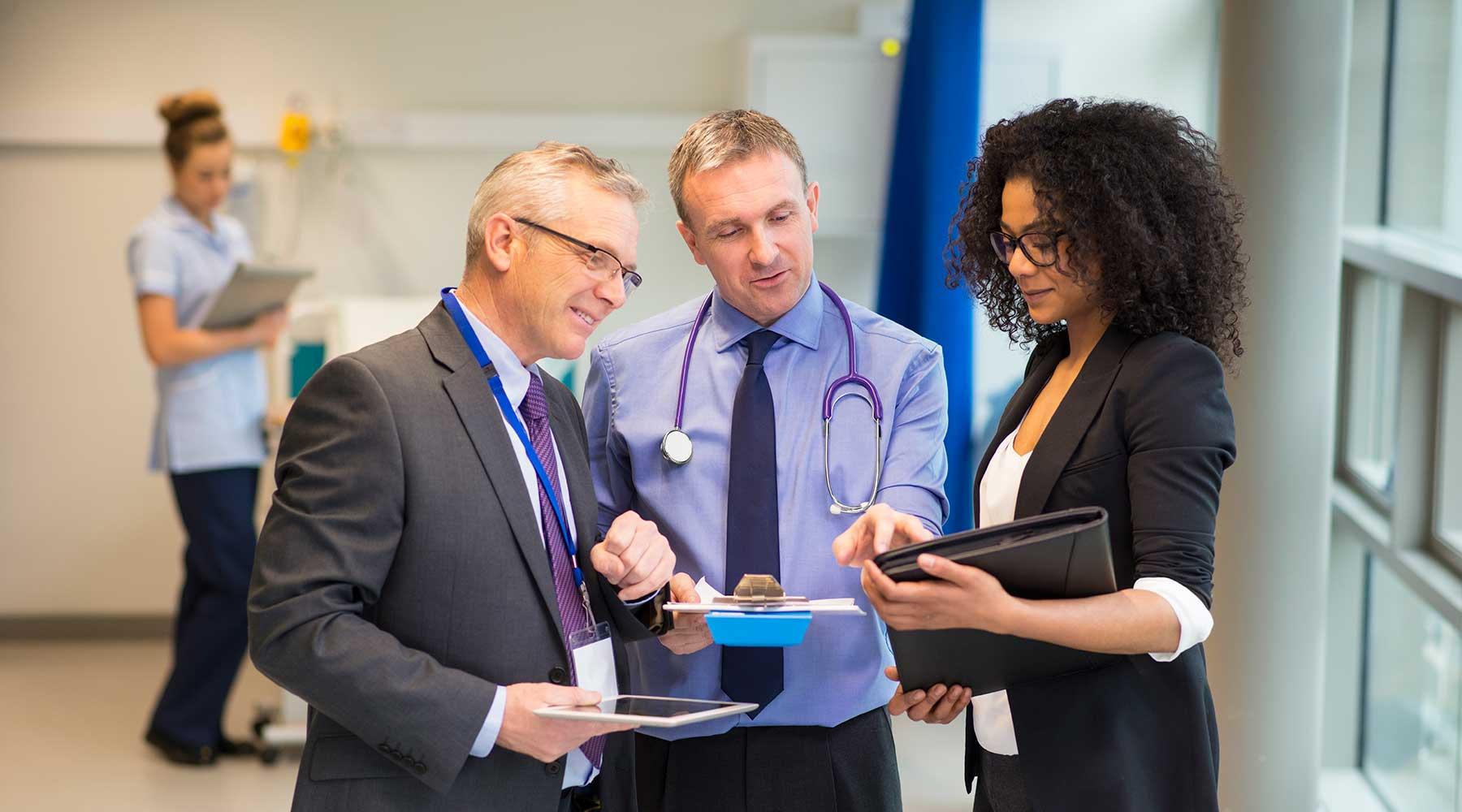 Group of medical workers looking at a clipboard