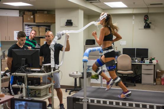 A student runs while wearing movement and oxygen sensors