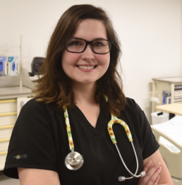 Student posing in nursing lab