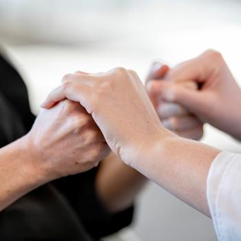 Physician assistant student checking a patient's strength 