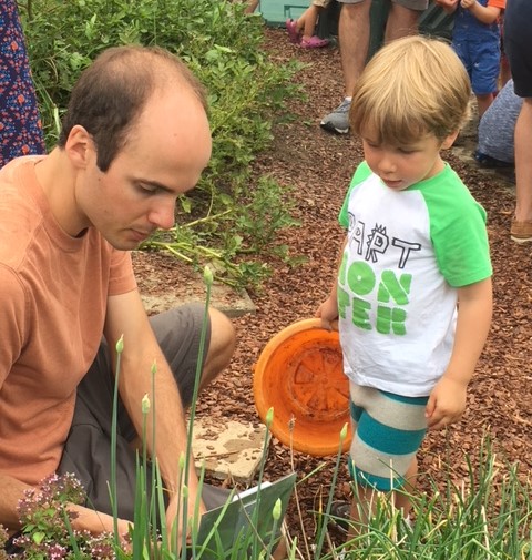 child and father discovering garden