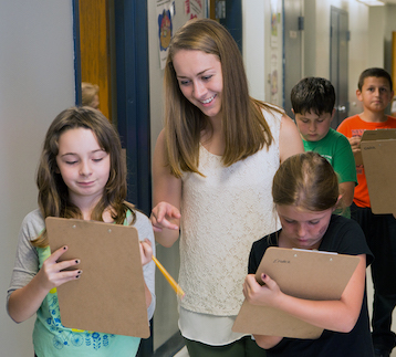 Student teacher working with young children.