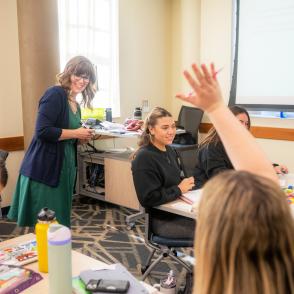 Student raising their hand in a classroom
