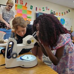 Kids looking at a microscope