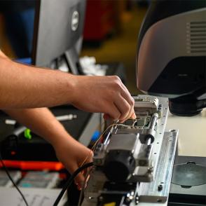 A student works on a machine.