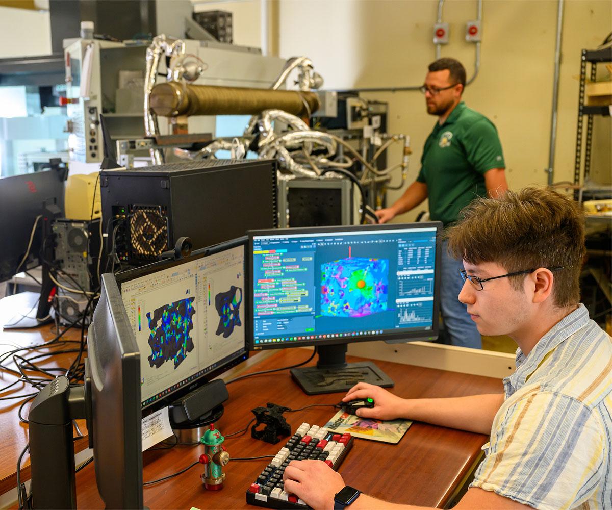Two researchers work in a CAMP lab.