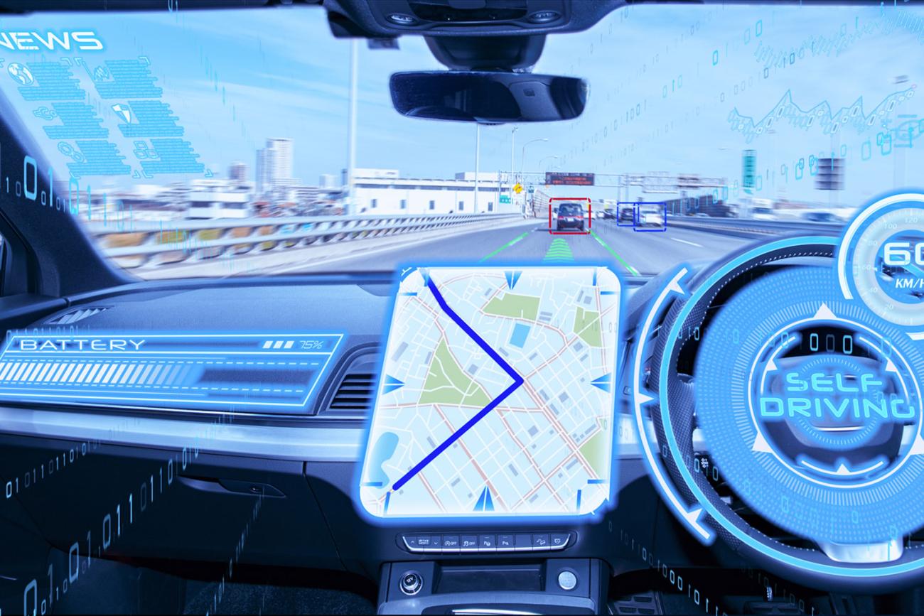 Inside of car dashboard showing news and navigation graphics projected onto windshield