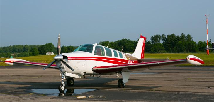 Bonanza A36 parked on landing strip