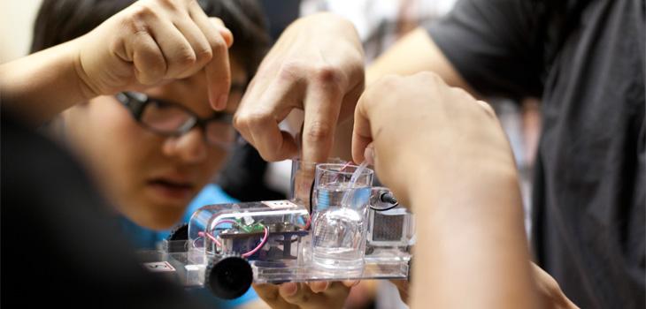 Students working on a chemistry powered car model