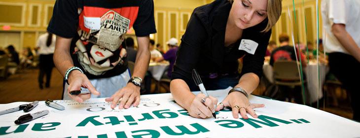 Leaders drawing and editing the pre printed banner.