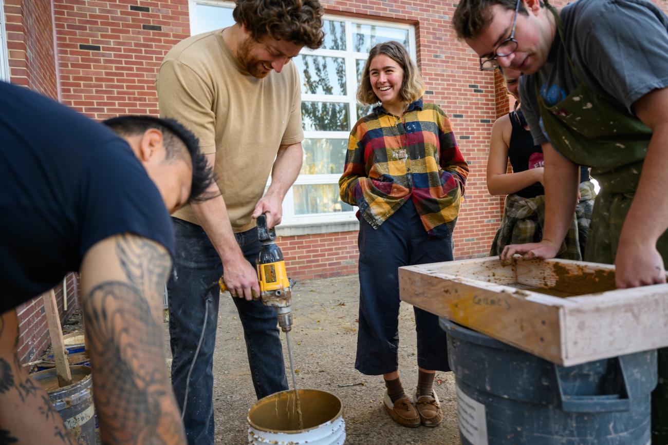 Students working on mixing clay for ceramics