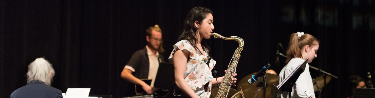 A student plays a saxophone during a concert.