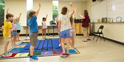 KidSing! students stand in a circle