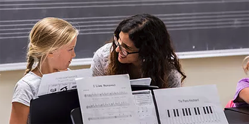 A student and instructor in private piano lessons