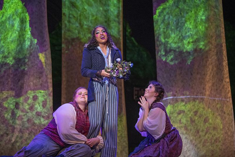Three performers on stage