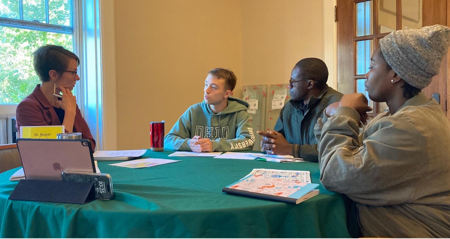 Students preparing for their pitch project with Dr. Allison Rollins.