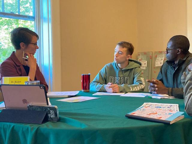 People at table engaged in conversation