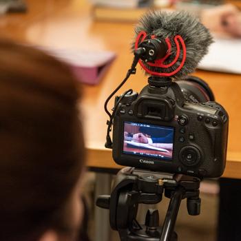 An Ohio University film team members looks at a camera shot