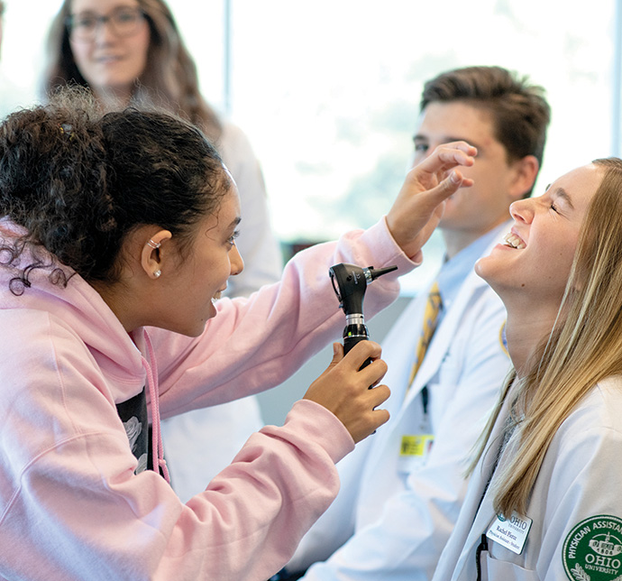Student examining mock patient