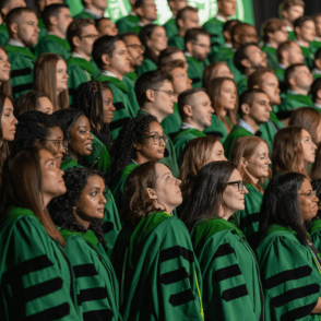 HCOM Graduates standing at Commencement Ceremony