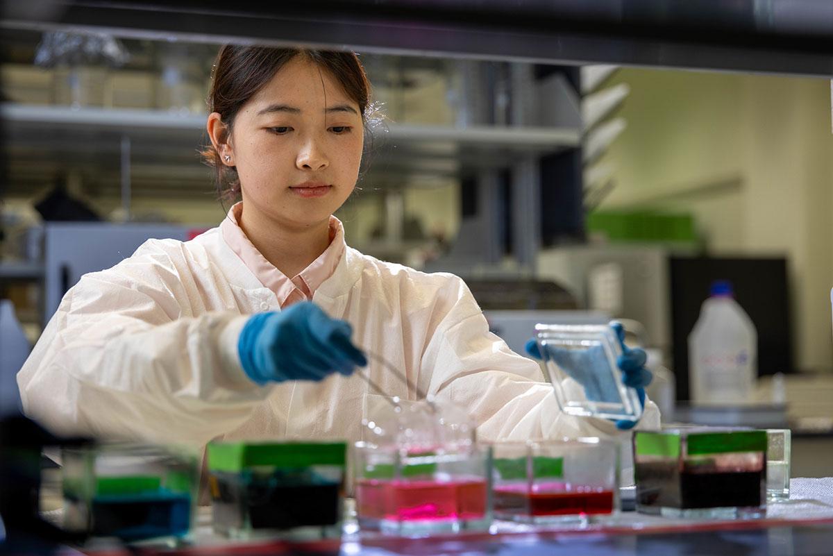 A medical student works with equipment in a lab setting