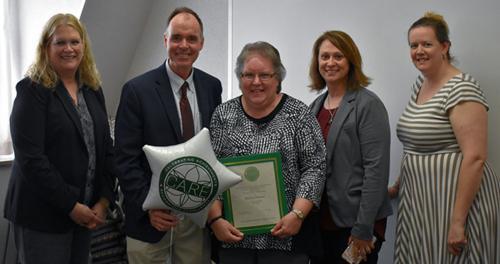 Miriam Thomas holding award