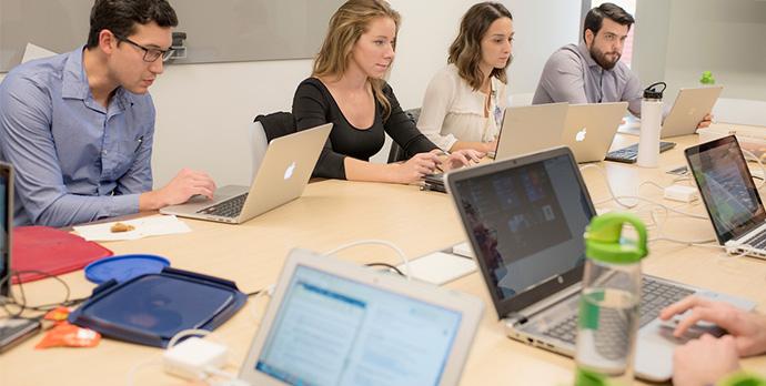 Students viewing books and computers