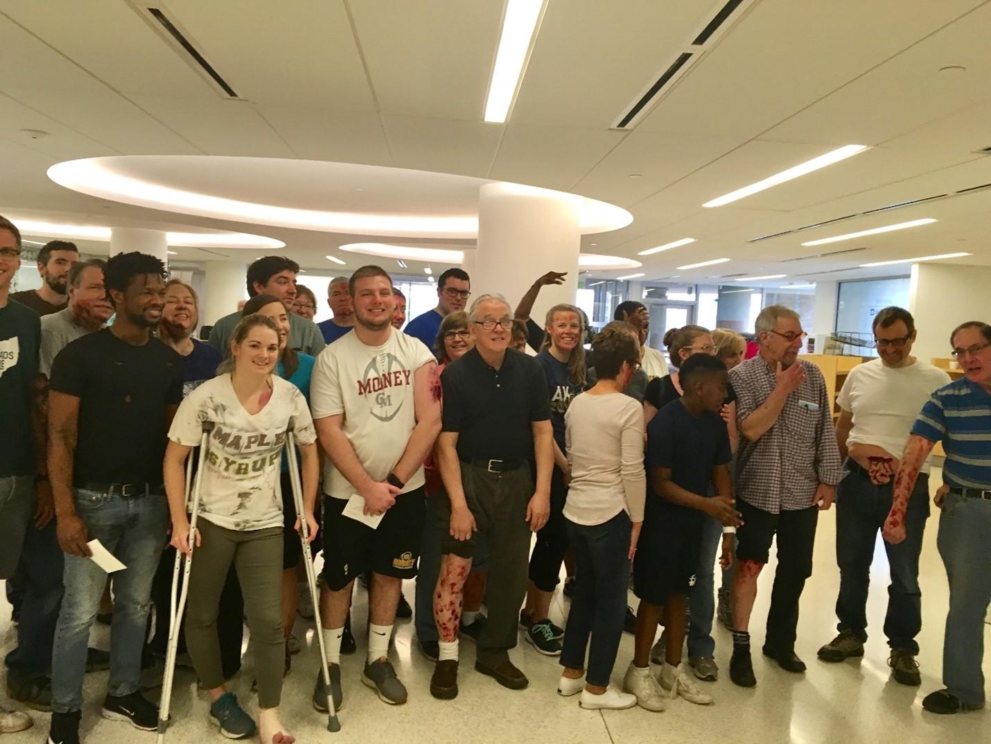 A group of 24 standardized patients pose for a photo