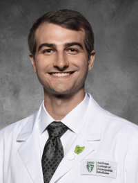 head shot of Tristan Myers in his white coat