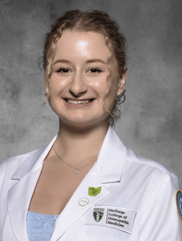 Head shot of Faye in white coat