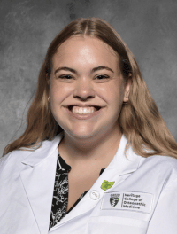 Head shot of Olivia in white coat