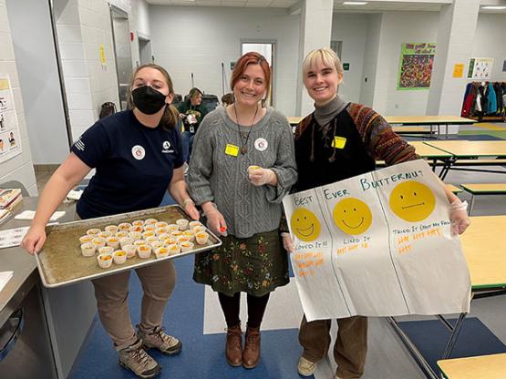 Three people serving healthy food